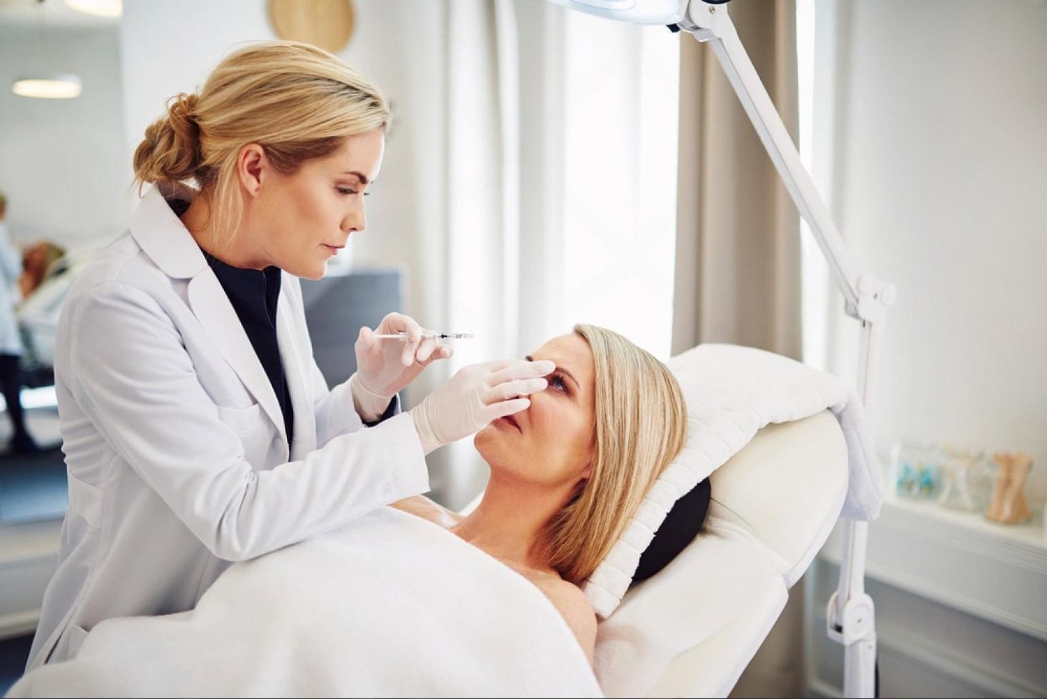 Doctor examining a patient's face during a preventive dermatology checkup in the UAE